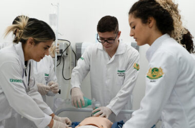 Estudantes de Enfermagem da Unoeste realizam treinamento prático em laboratório, utilizando manequim para simulação de atendimento com suporte respiratório, em ambiente hospitalar.