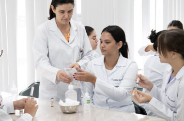 Professora orienta estudantes de Enfermagem da Unoeste durante aula prática com seringas e materiais utilizados em procedimentos de saúde.